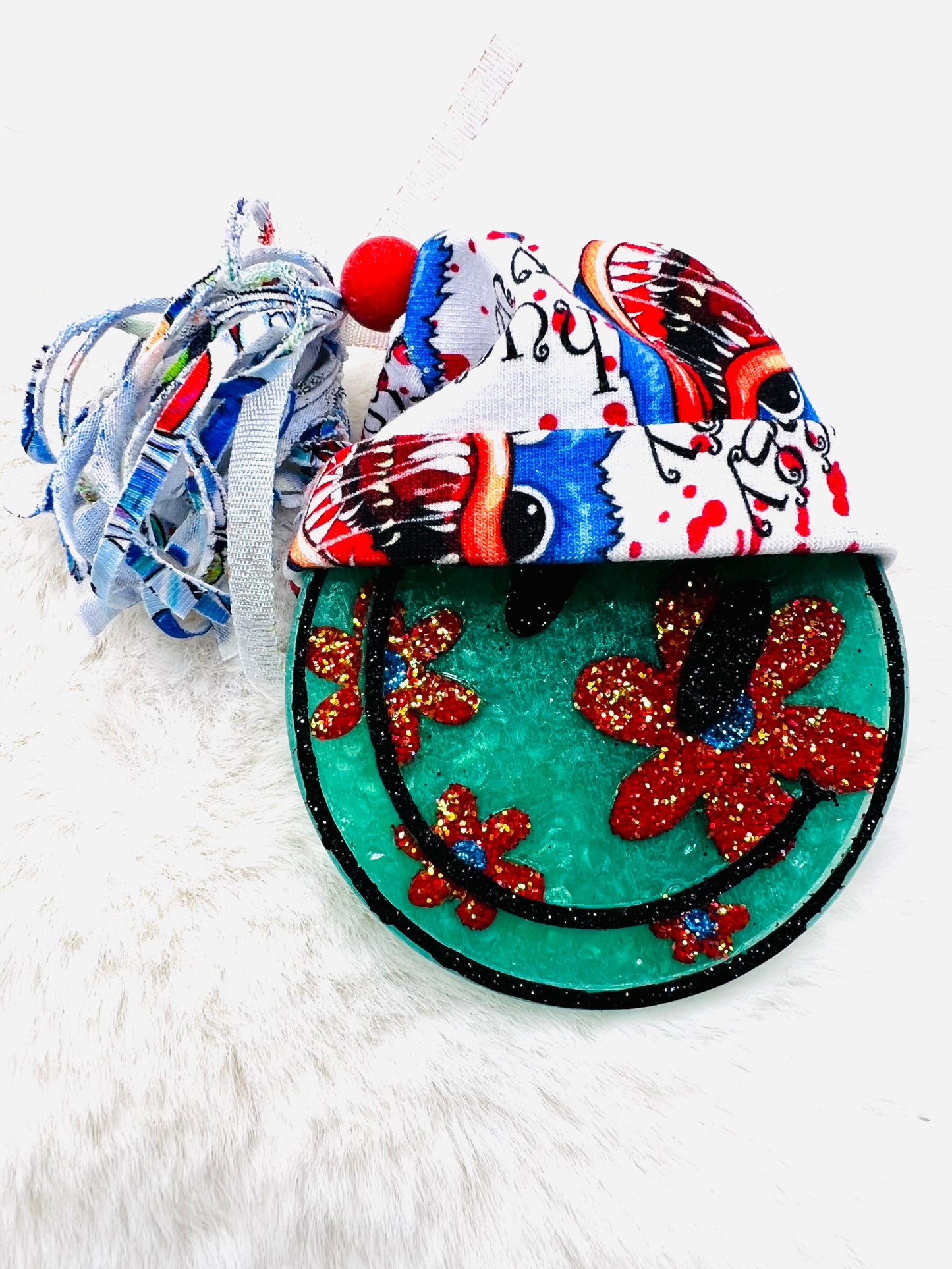 Colorful decorative happy face freshie with floral design on a white background