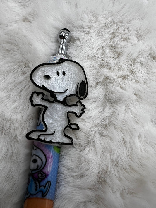 Snoopy character on the top of a pen against a fluffy white background