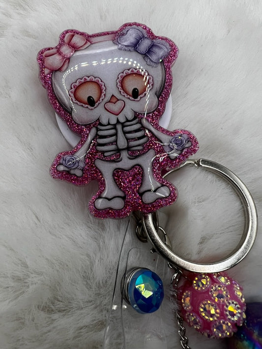 Keychain with a cartoon skeleton character on a fluffy white background