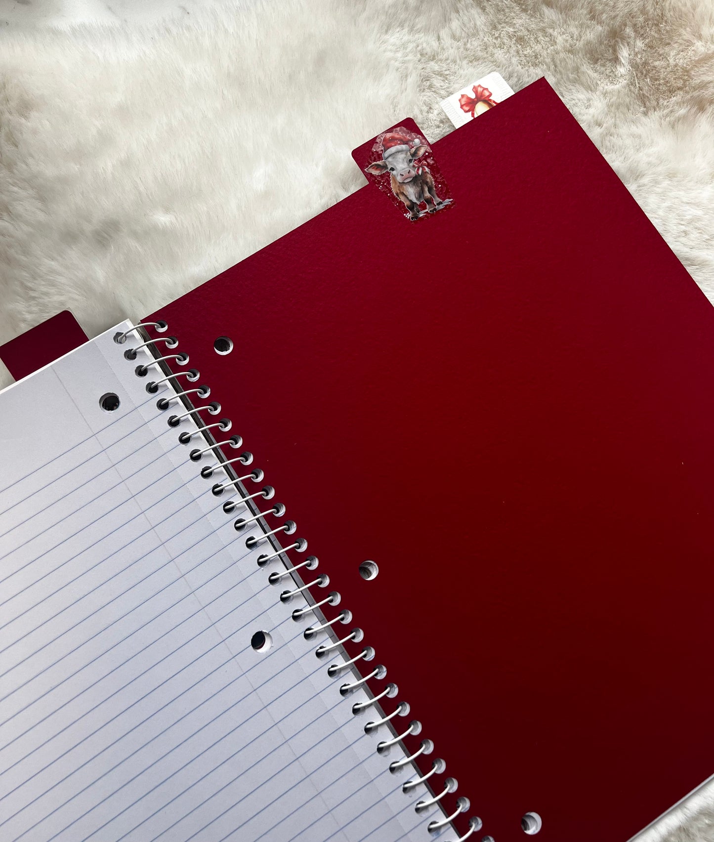 Red notebook with a white lined page on a textured surface
