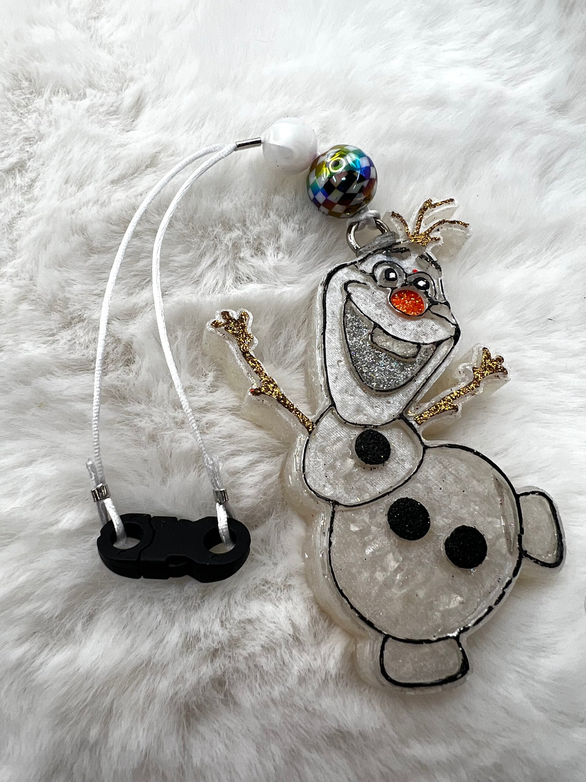 Snowman character Olaf freshie with a colorful bead on a white fluffy background