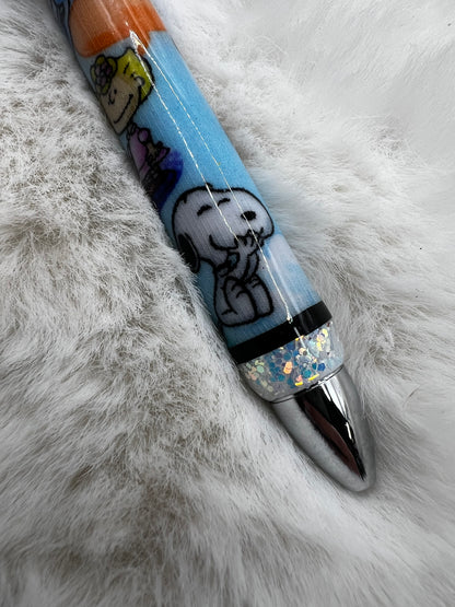Pen with Snoopy design on a fluffy white surface
