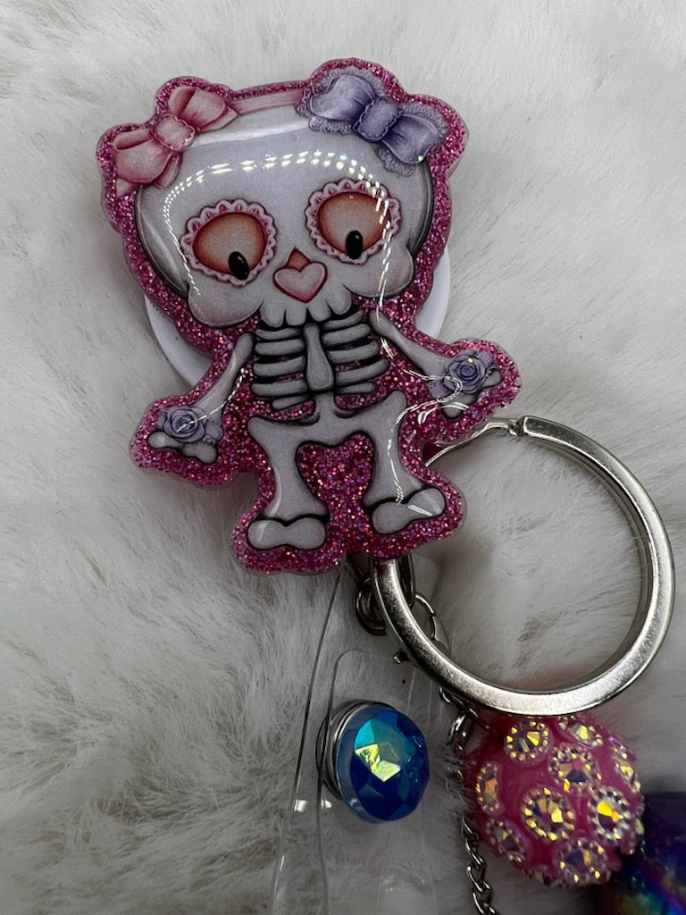Keychain with a cartoon skeleton character on a fluffy white background