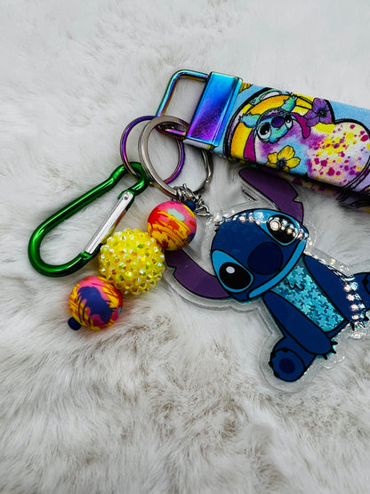 Colorful keychain with cartoon character Stitch, on a textured surface