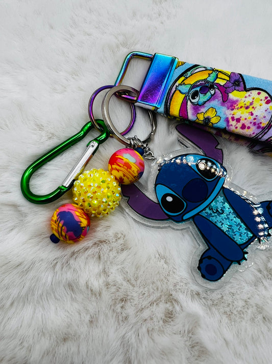 Colorful keychain with cartoon character Stitch, on a textured surface