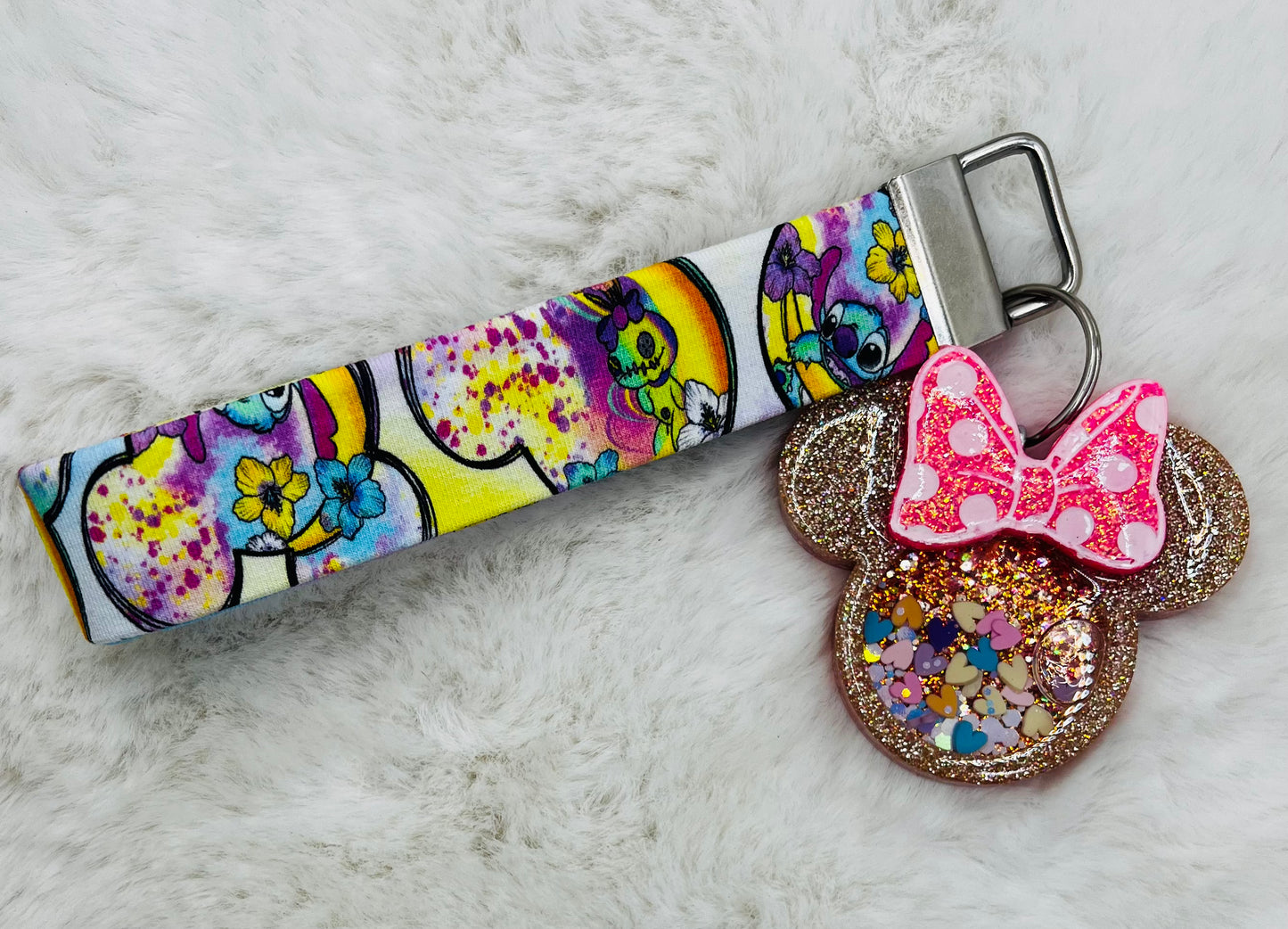 Colorful keychain with featuring Minnie Mouse and Stitch on a textured surface
