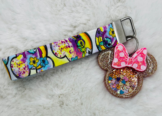 Colorful keychain with featuring Minnie Mouse and Stitch on a textured surface
