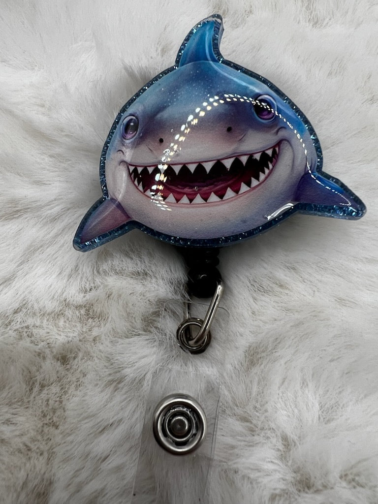 Shark-shaped badge holder on a fluffy white background