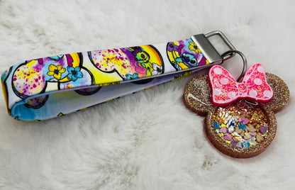 Colorful keychain with featuring Minnie Mouse and Stitch design on a textured surface