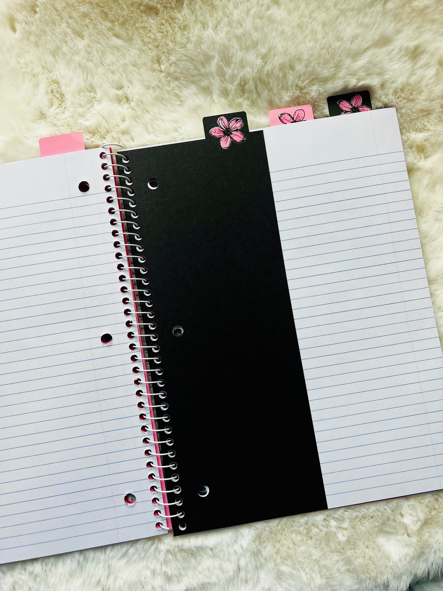 Notebook with a black divider page on a textured surface