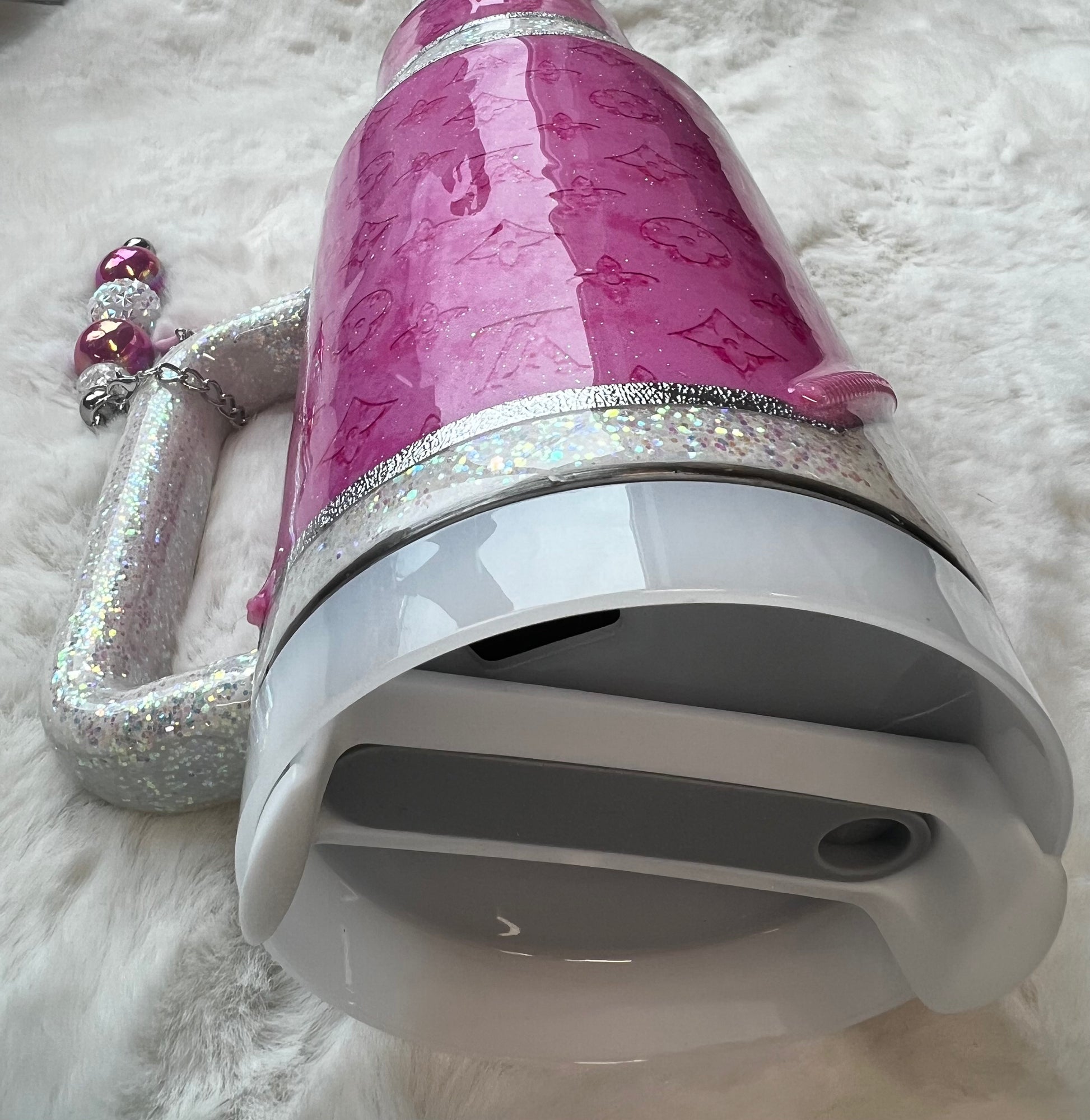 Pink sparkly tumbler set on a fluffy surface