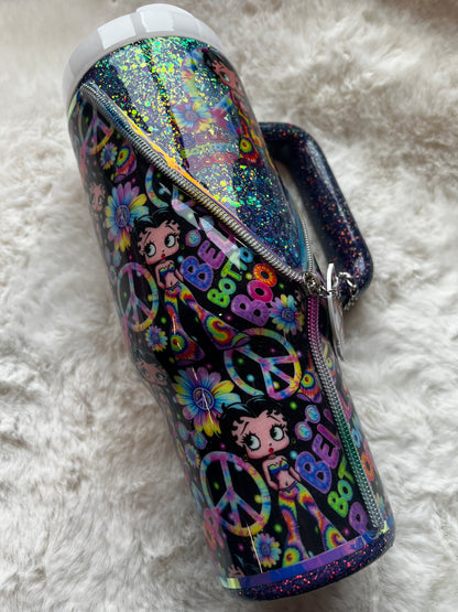 Colorful glittery tumbler with Betty Boop character design on a white fluffy surface