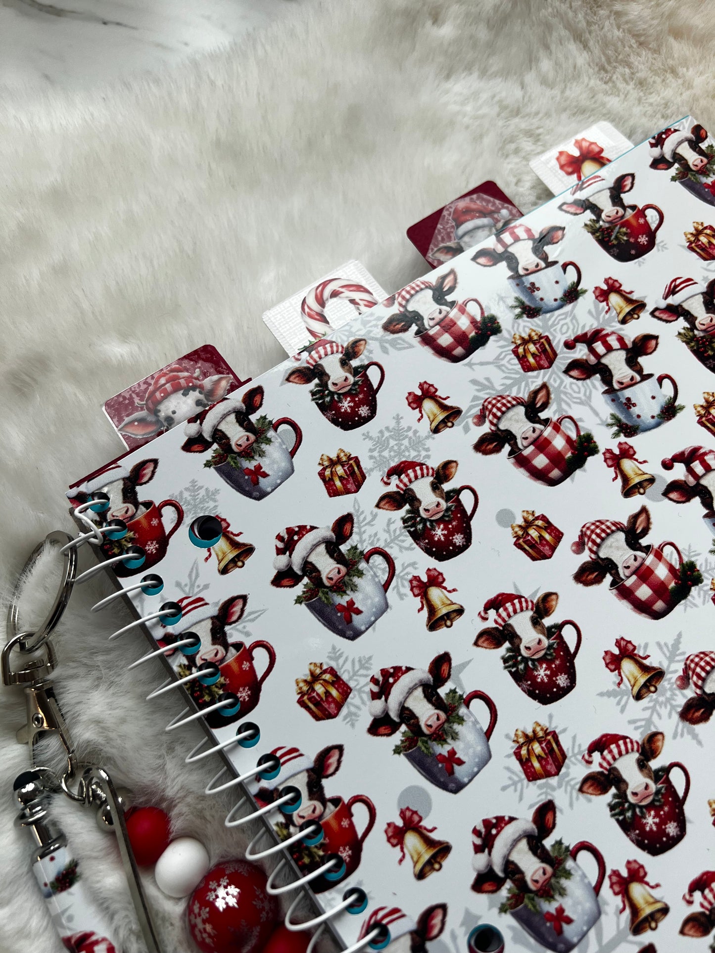 Decorative planner stickers with Christmas-themed cow designs on a textured surface.