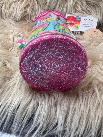 Pink glittery tumbler on a fluffy beige surface