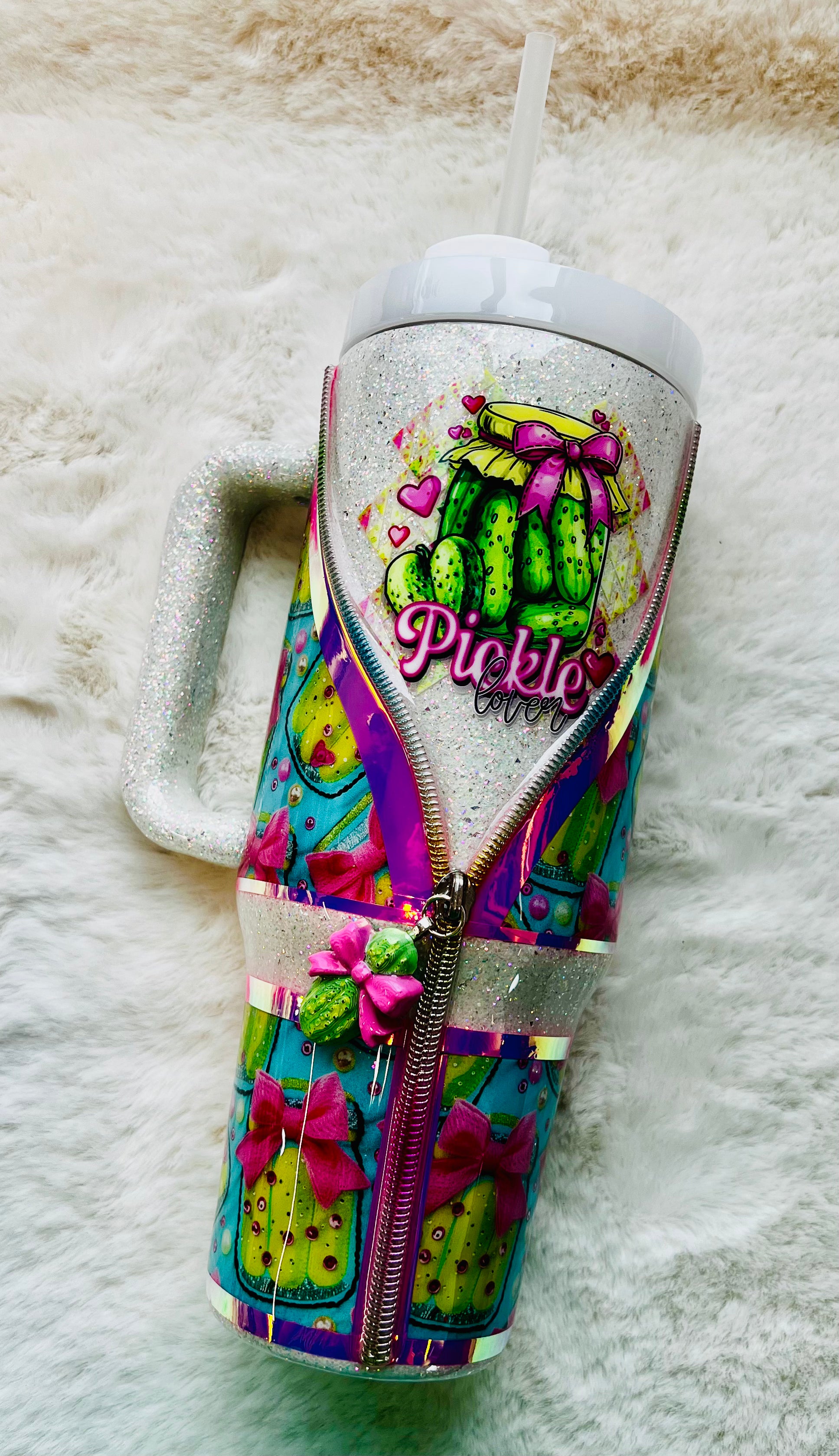 Colorful stainless steel tumbler with a pickle design and 'Pickle' text on a textured surface.