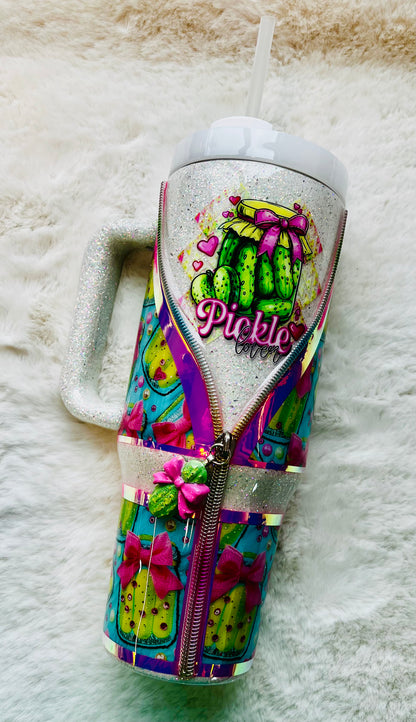 Colorful stainless steel tumbler with a pickle design and 'Pickle' text on a textured surface.