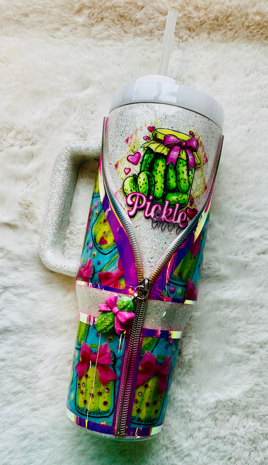 Colorful stainless steel tumbler with a pickle design and 'Pickle' text on a textured surface.