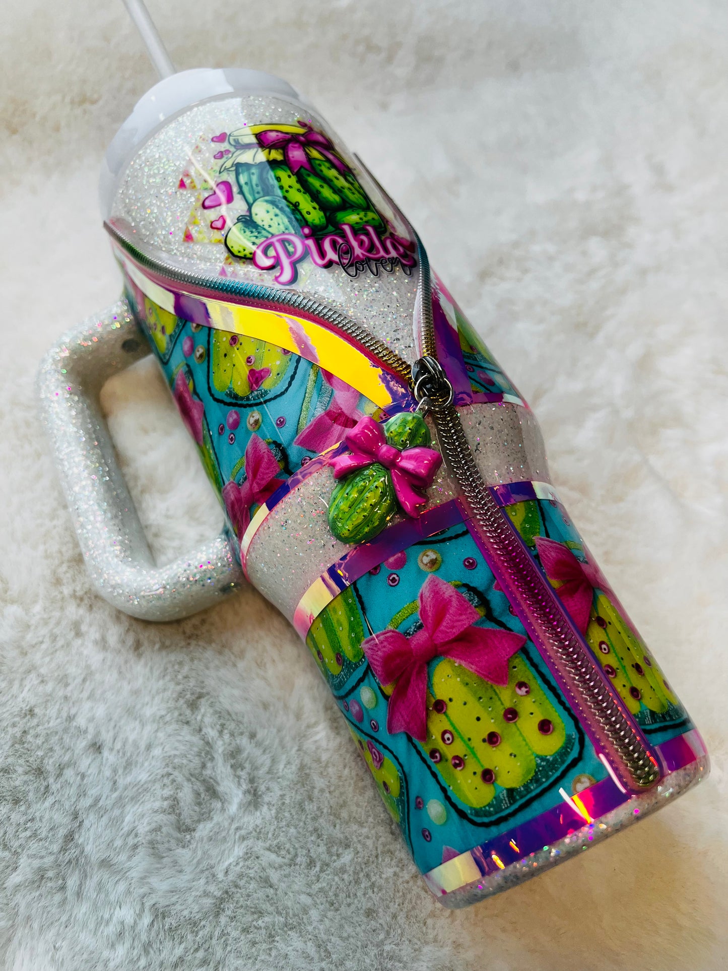 Colorful stainless steel tumbler with a pickle design and 'Pickle' text on a textured surface.