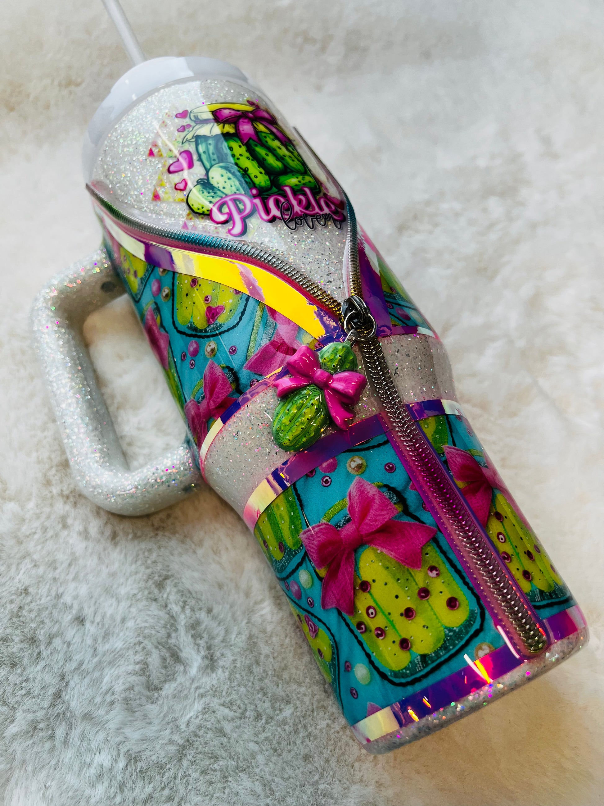 Colorful stainless steel tumbler with a pickle design and 'Pickle' text on a textured surface.