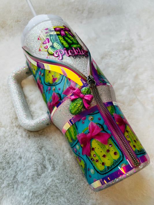 Colorful stainless steel tumbler with a pickle design and 'Pickle' text on a textured surface.