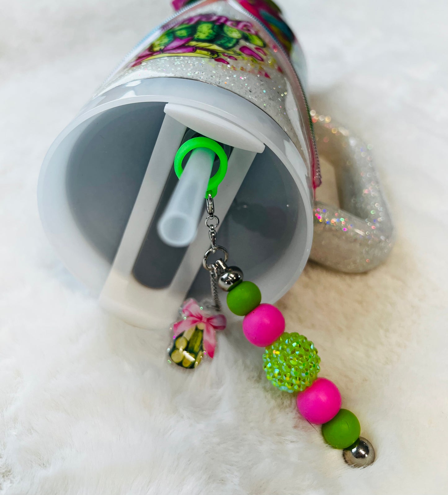 Colorful stainless steel tumbler with a pickle design and 'Pickle' text on a textured surface.