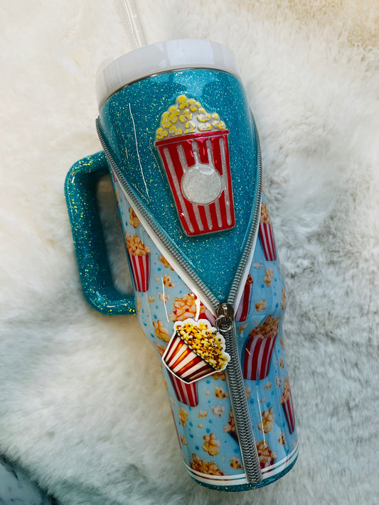 Tumbler with popcorn design on a fluffy white surface