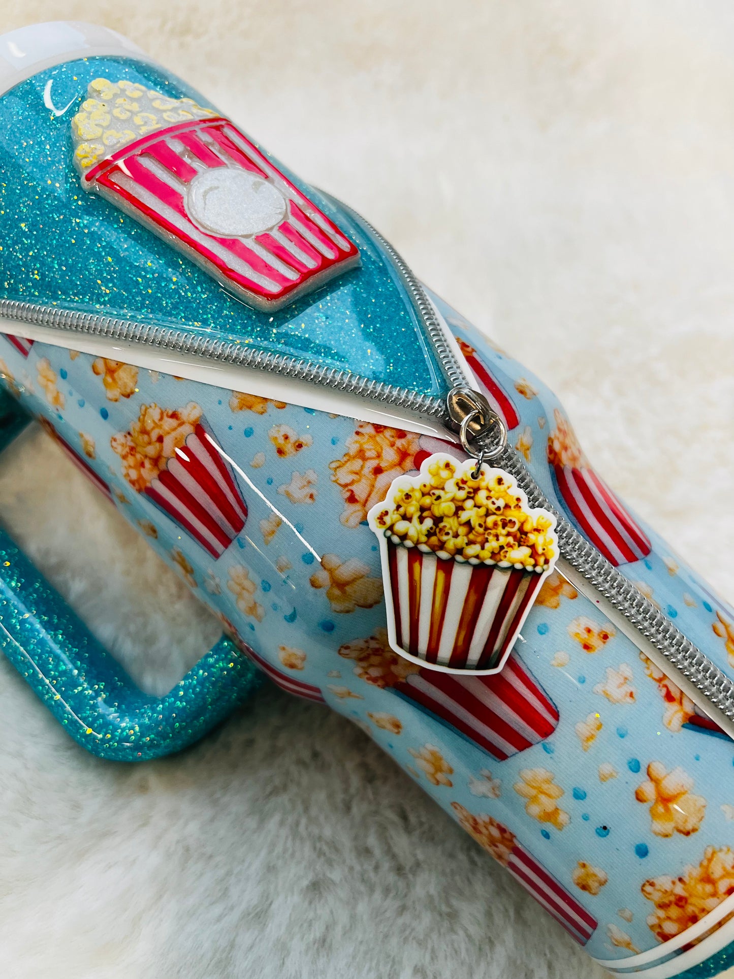 Tumbler with popcorn and movie theater design on a light background