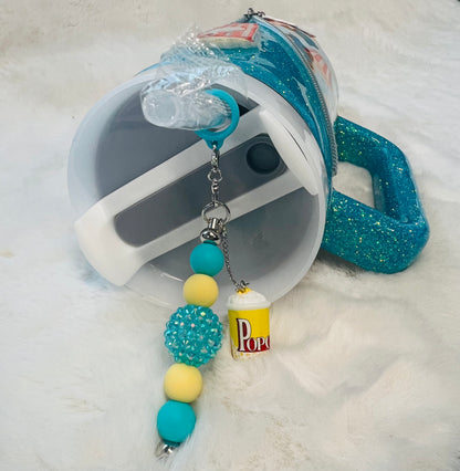 Tumbler with popcorn design on a fluffy white surface